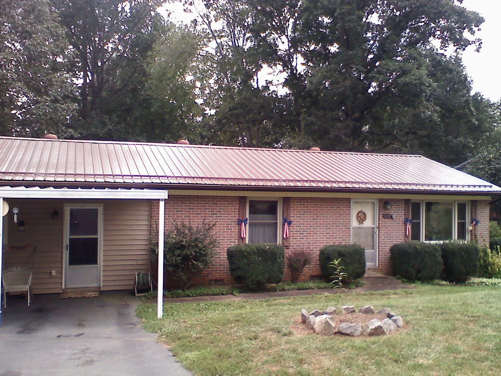 Bronze metal roof and carport on a brick ranch home — Roof Repair work by our crew in Tarzana